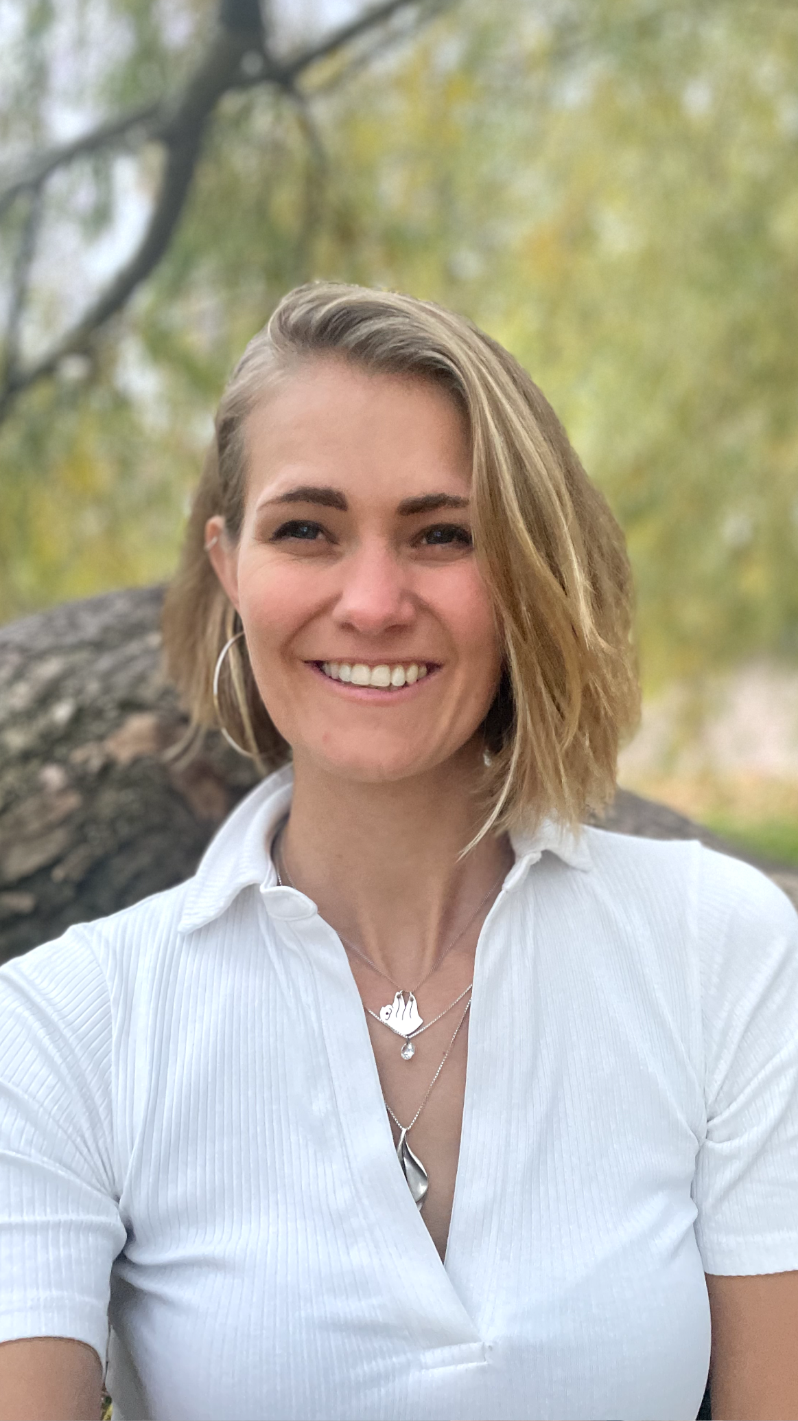 A picture of Kajsa Tunius smiling in a black balzer with a white top.